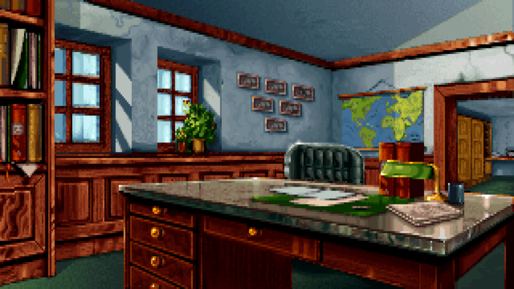 An empty office room decorated with wooden furniture and a map of the world.